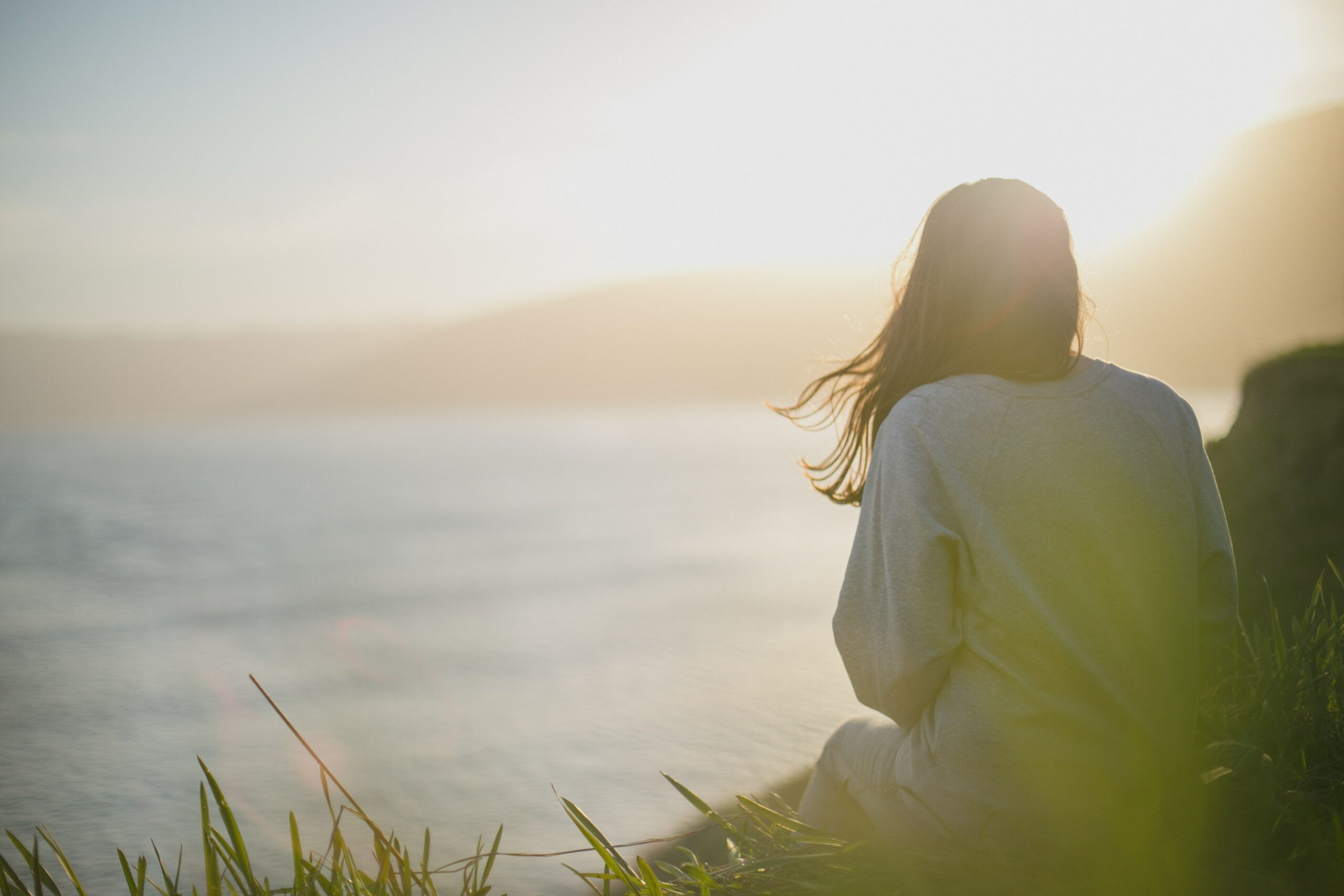 A woman watching a sunset on a beach