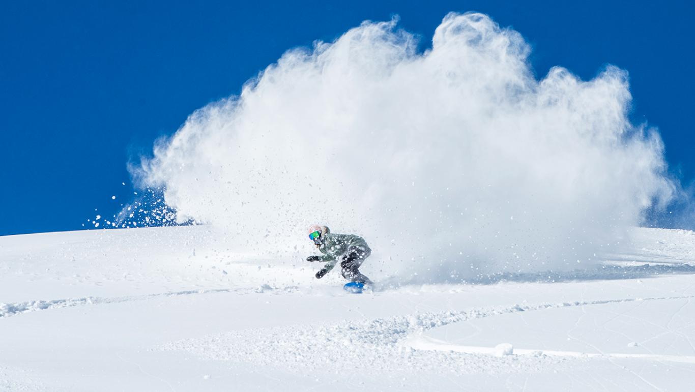 A snowboarder riding down Mt bachelor - one of the things to do in Bend, Oregon