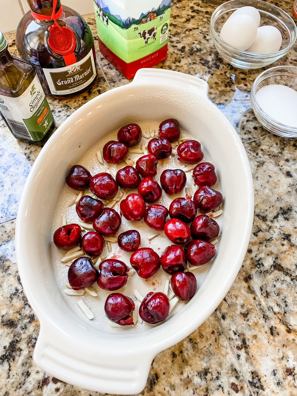 Fresh cherries and slivered almonds lining a baking dish