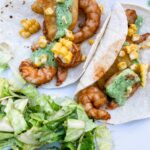 Two of the finished Sheet Pan Shrimp Street Tacos on a plate