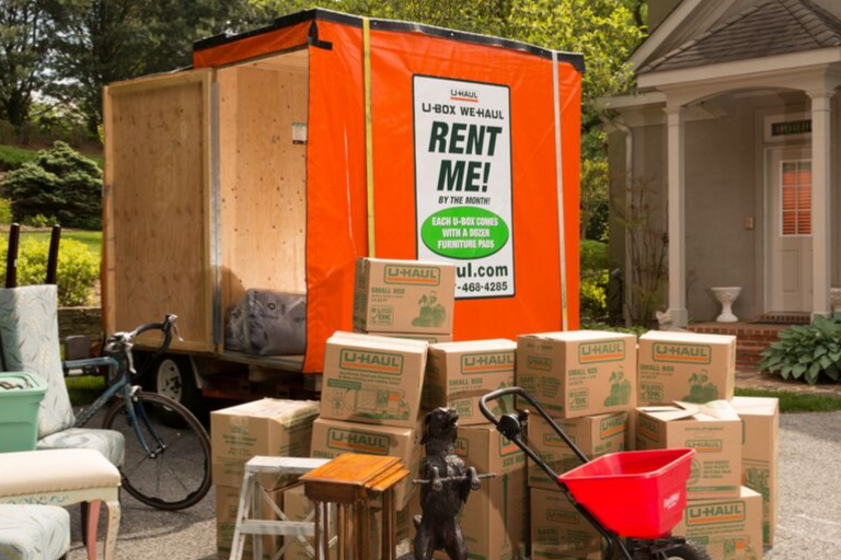 A U-box with household items around it, ready to be packed.