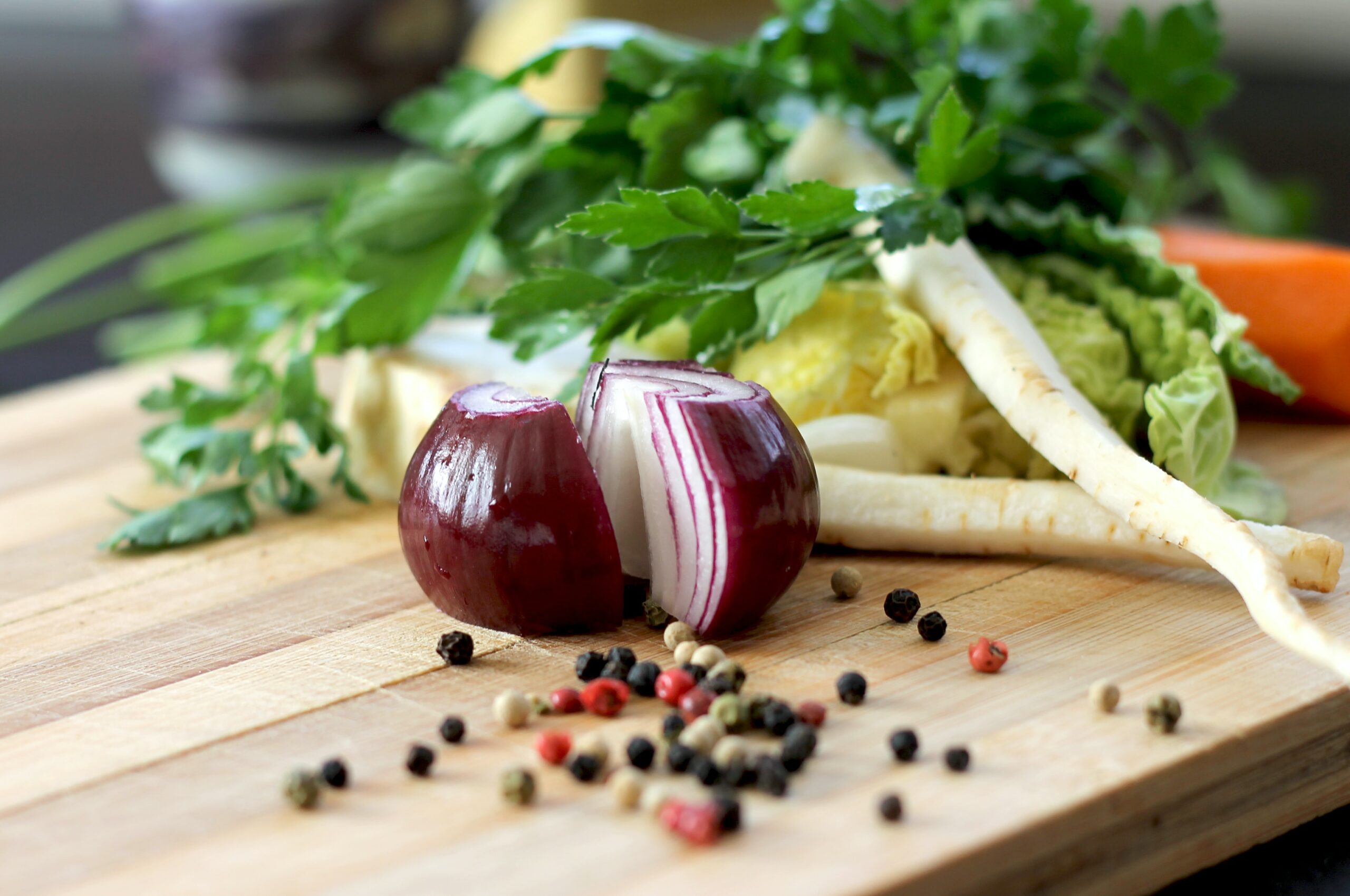 Fresh food - onions, peppercorns, roots, on a cutting board, one of the re-beginning being made because of covid