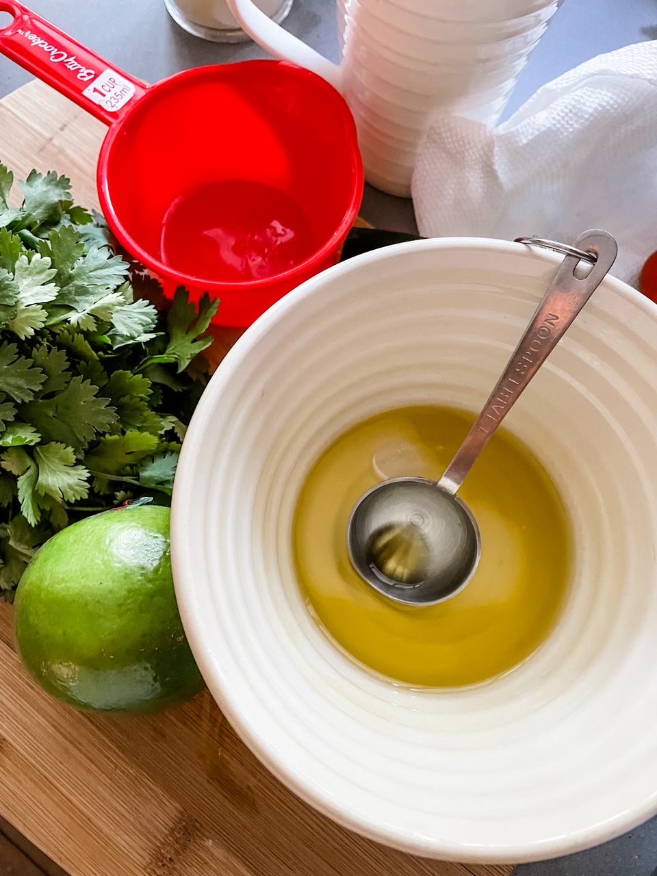 The ingredients for the avocado dressing - cilantro, avocado, and olive oil