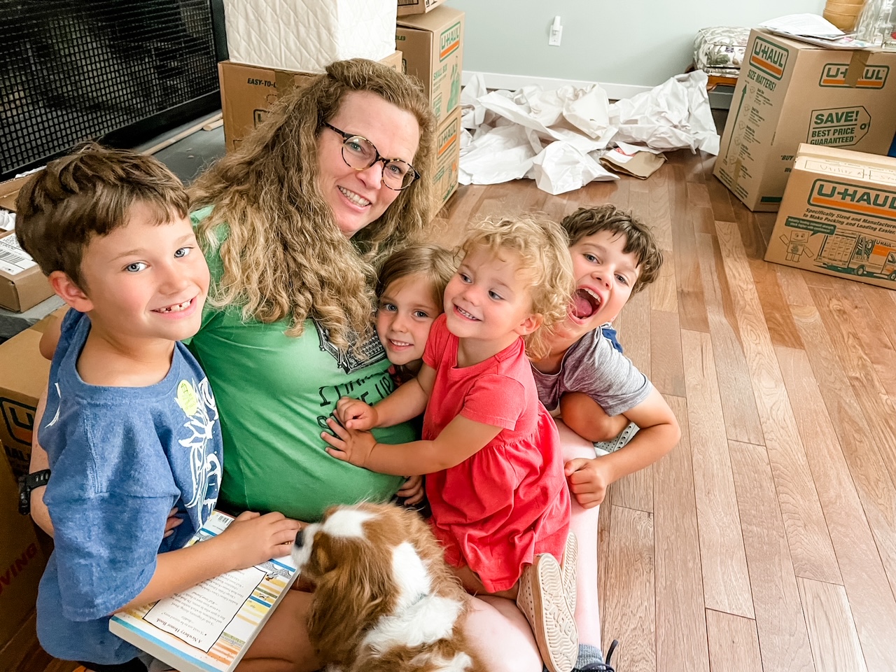 Marie and her four grandchildren posed together among moving boxes