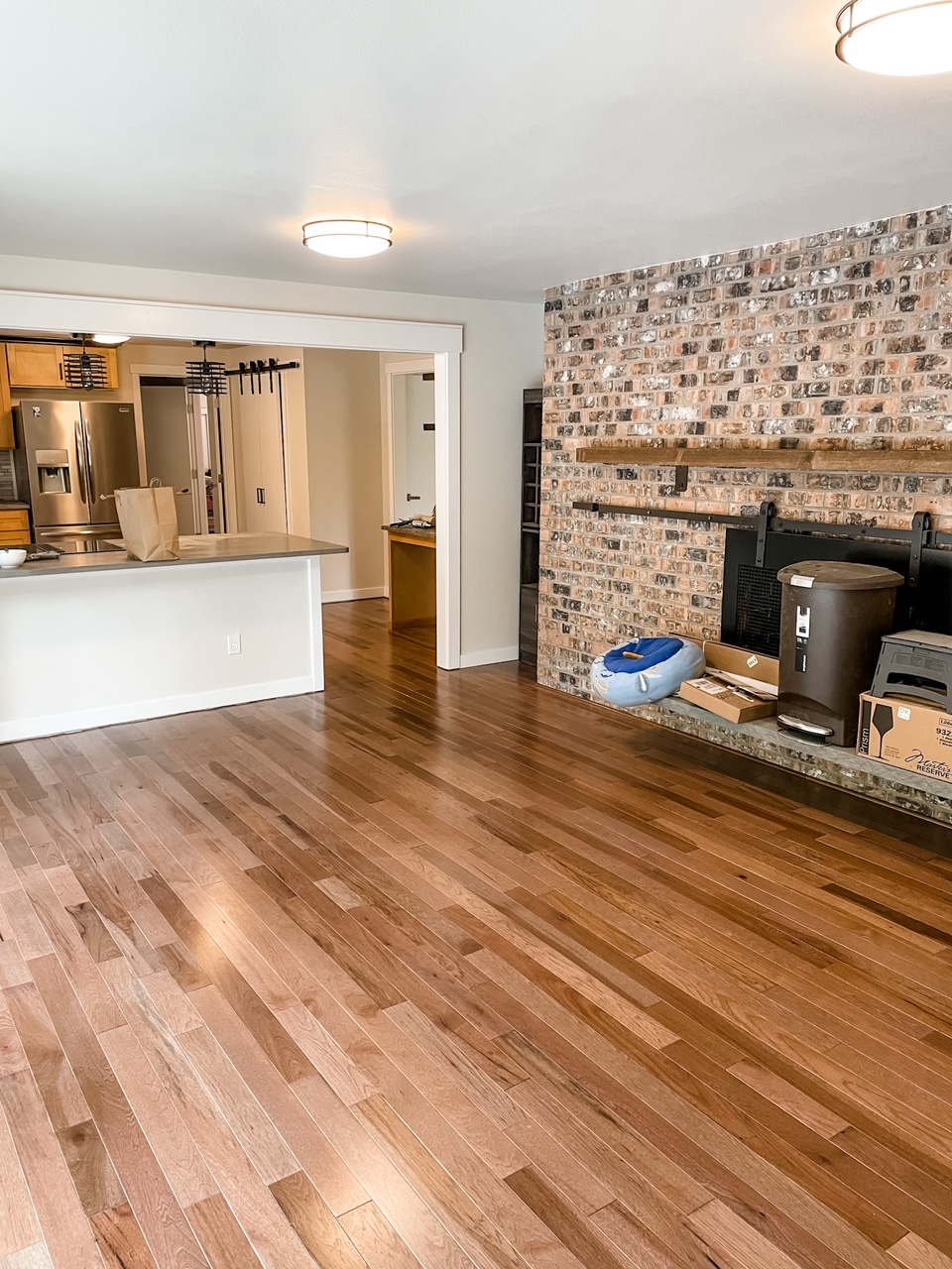 The after portion of the wooden flooring Remodeling Before and After - a warmer color of wood