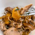 A fork digging into the Slow Cooker Ginger Peach Chicken