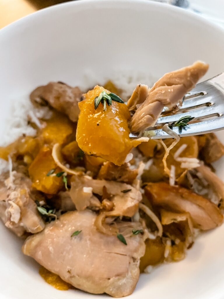 A fork digging into the Slow Cooker Ginger Peach Chicken