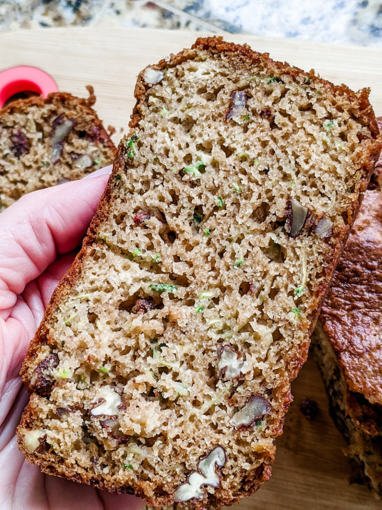 A slice of the zucchini cardoman bread, a recipe on the 28 Rainy Day Activities for Adults list