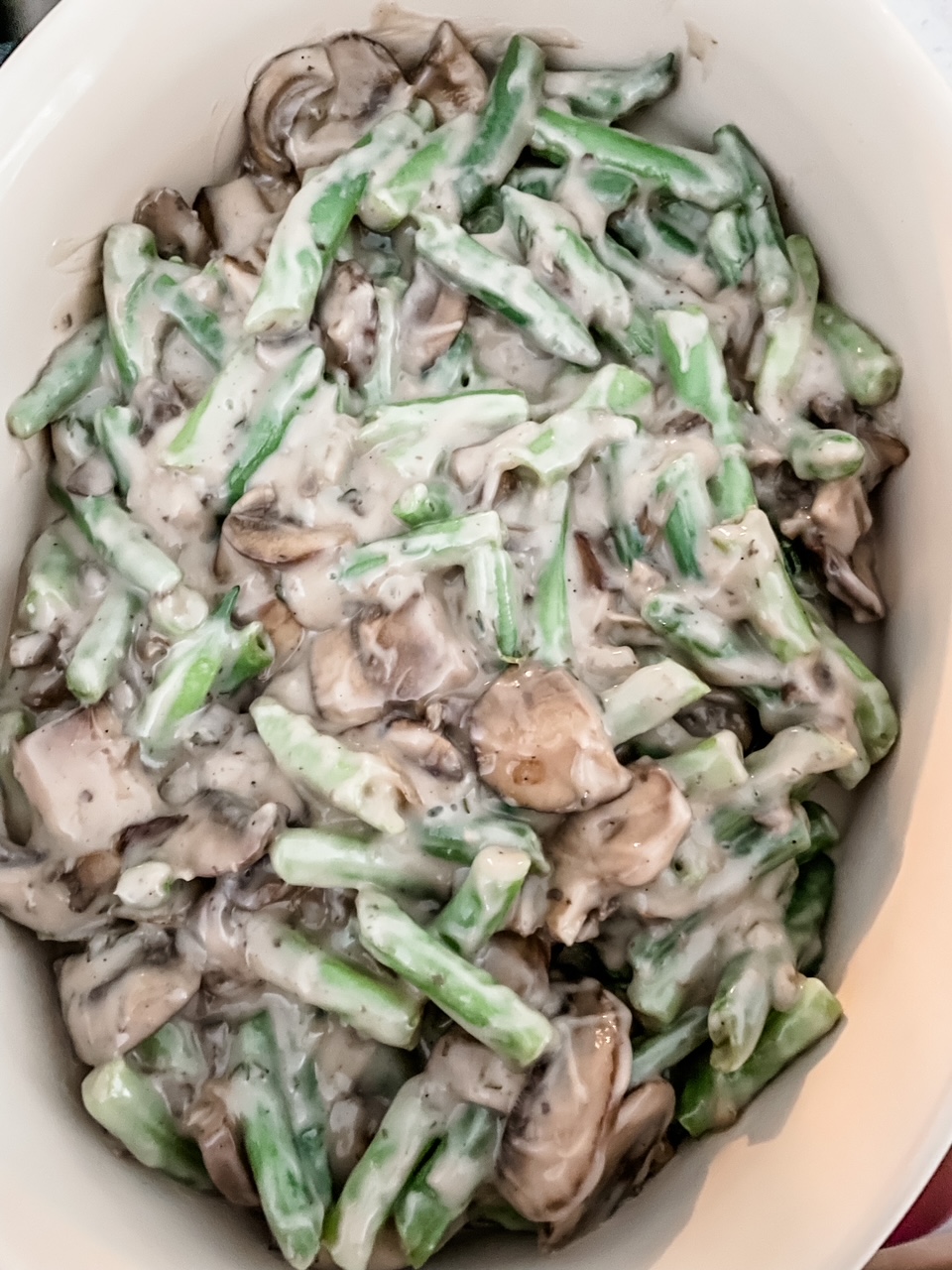 The Easy Healthier Green Bean Casserole without the topping, showing the mixture of soup, green beans, and mushrooms