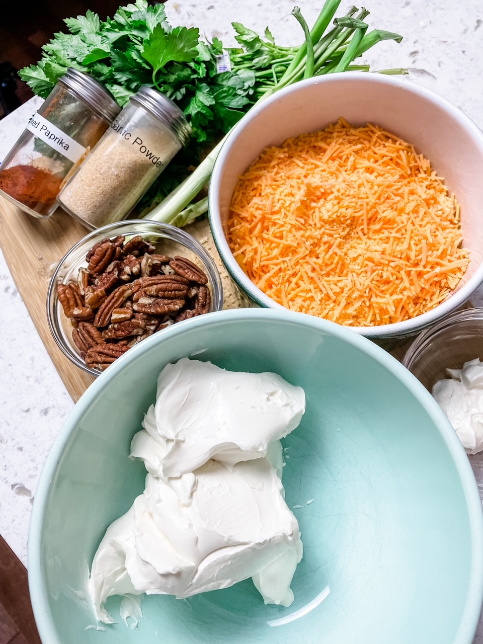 The ingredients for the Best Holiday Cheese Ball - cream cheese, spices, and cheddar cheese