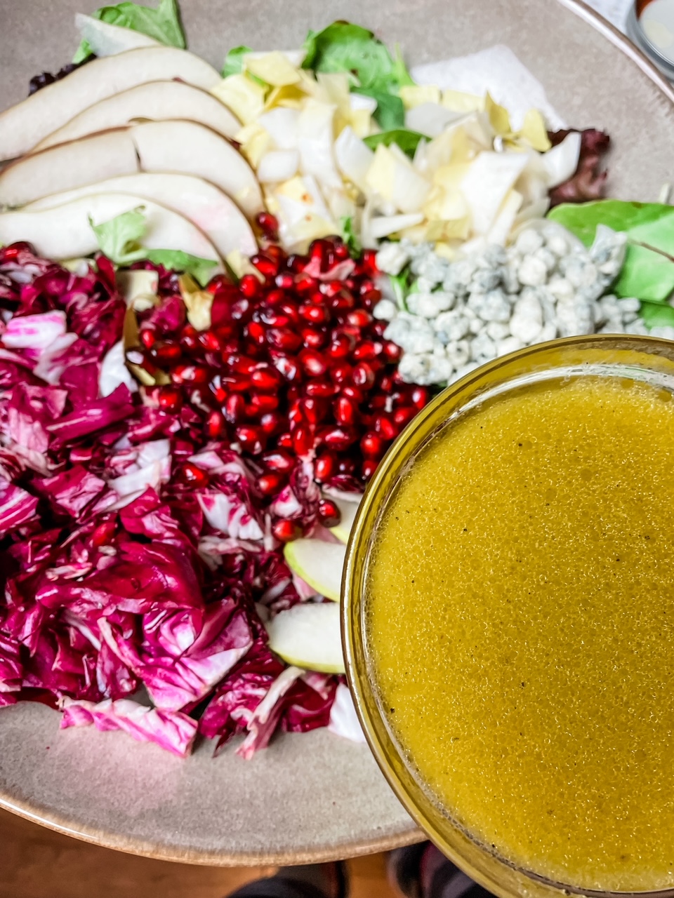 The Pomegranate and Pear Salad with Citrus Dressing in a bowl