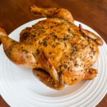 The finished Basic Herb-Roasted Chicken resting on a white plate