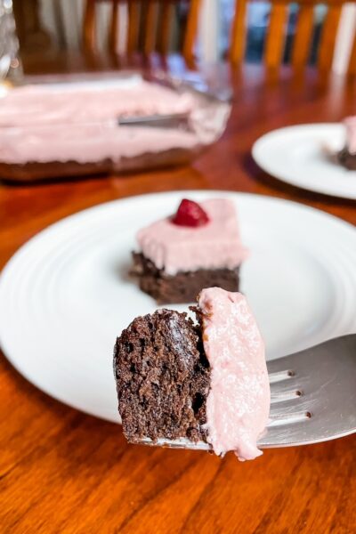 The finished Easy Raspberry Chiffon Brownie Cake with a fork displaying a piece of it
