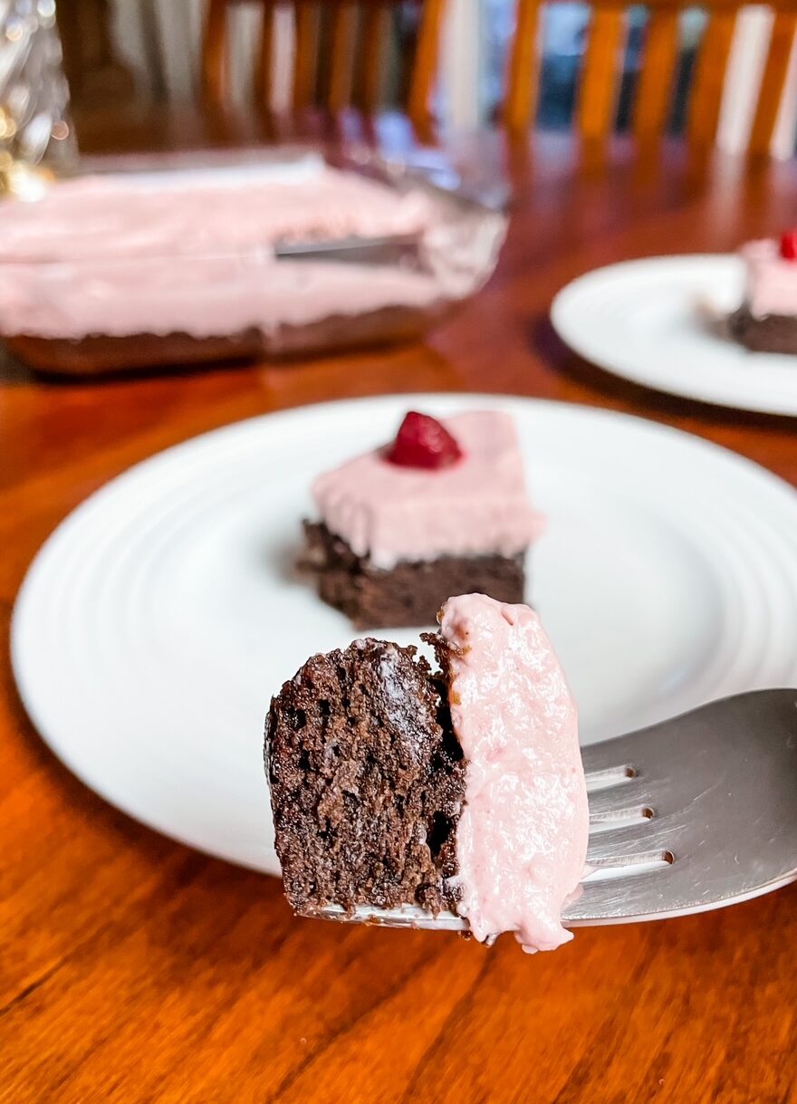 The finished Easy Raspberry Chiffon Brownie Cake with a fork displaying a piece of it