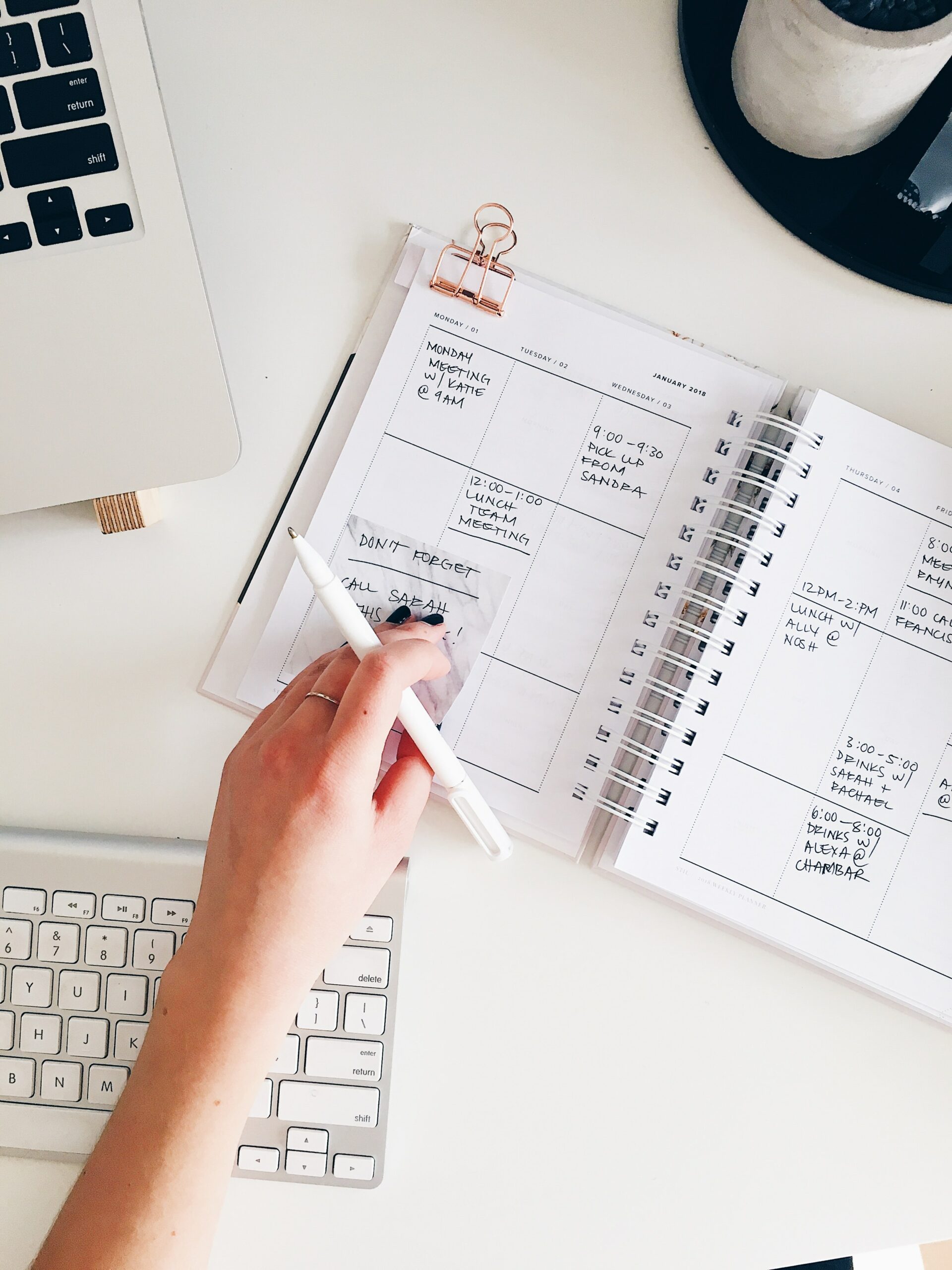 A woman writing in her planner - a suggestion to help with financial stability