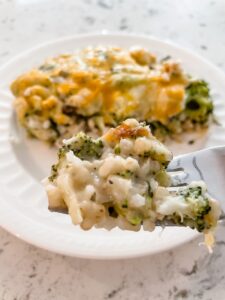 A fork lifting a bite of the Healthier Broccoli Rice Casserole with Chicken up