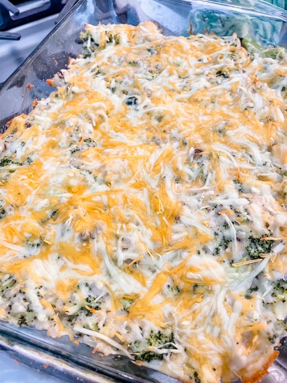 The finished Healthier Broccoli Rice Casserole with Chicken in a clear casserole dish