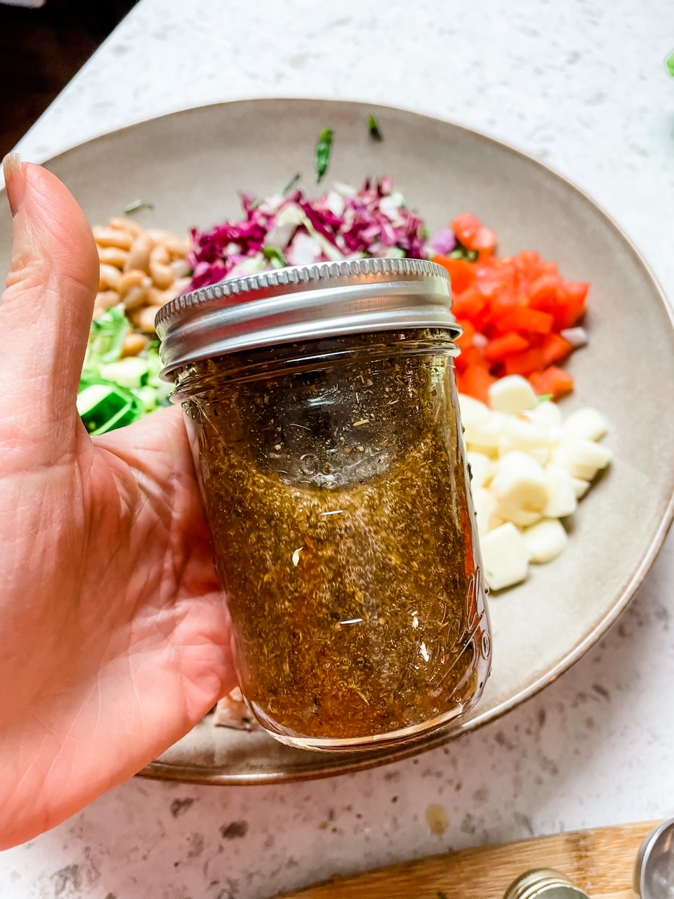 The homemade dressing in a bell jar