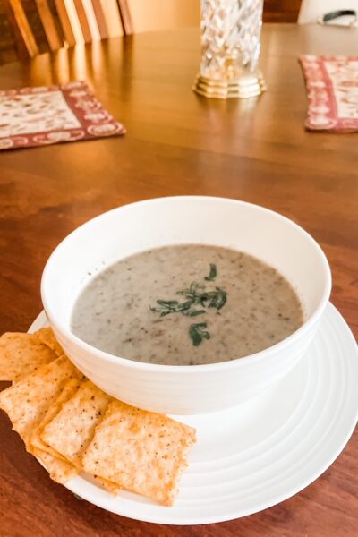 A bowl of the Creamy Garlic Mushroom Soup with crackers served alongside