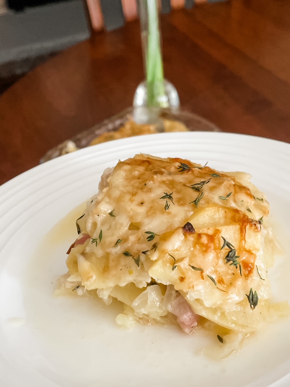 A slice of the Sweet Potato Gratin with Ham on a white plate