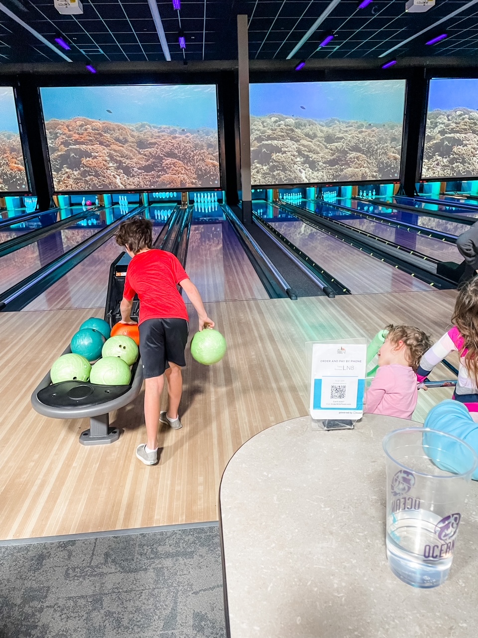 Marie's grandson preparing to take his turn at a bowling alley