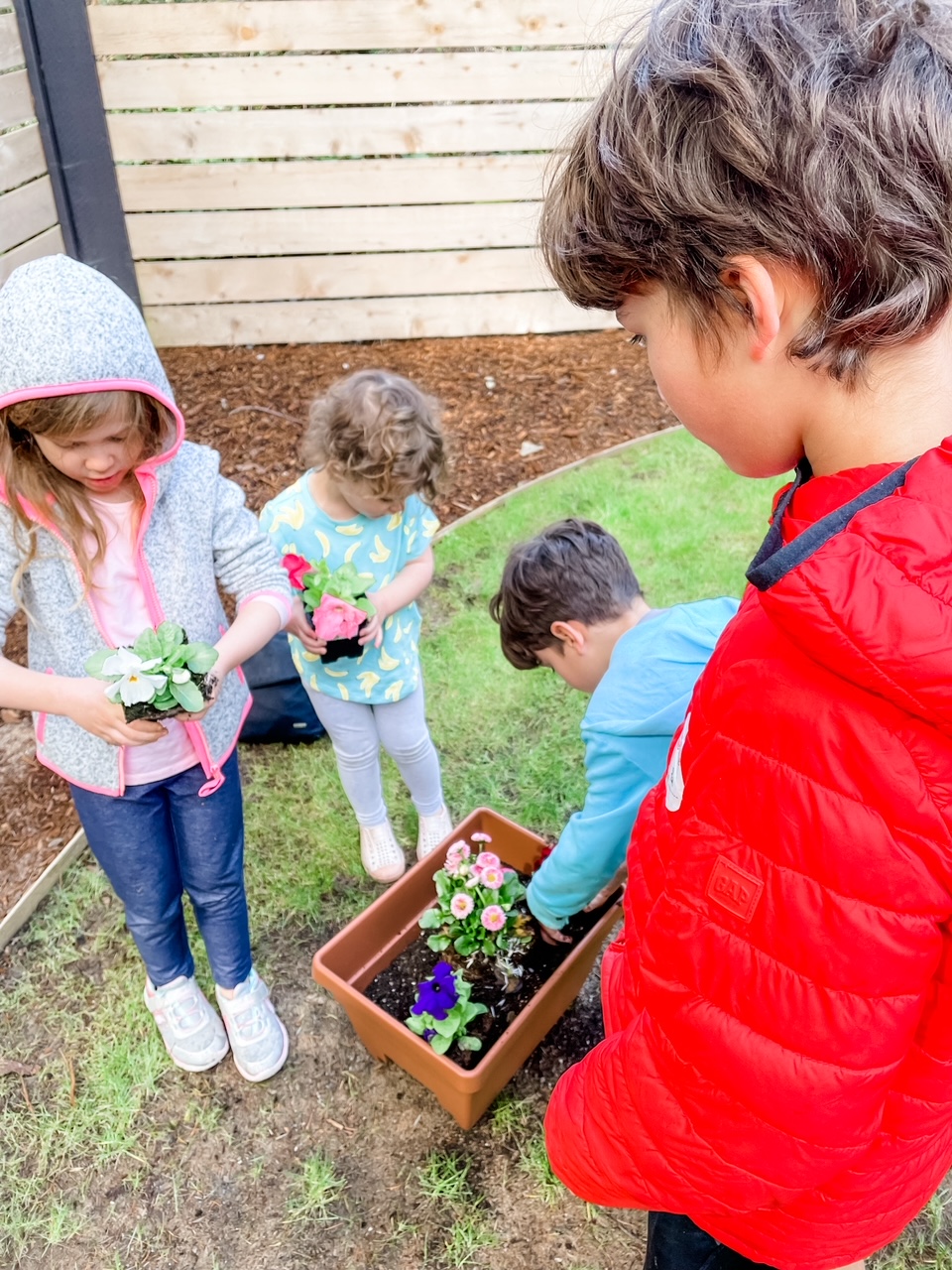 Marie's grandkids preparing to plant some flowers