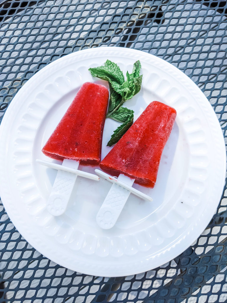 Two of the strawberry daiquiri pop on a white plate - one of the unique strawberry recipes