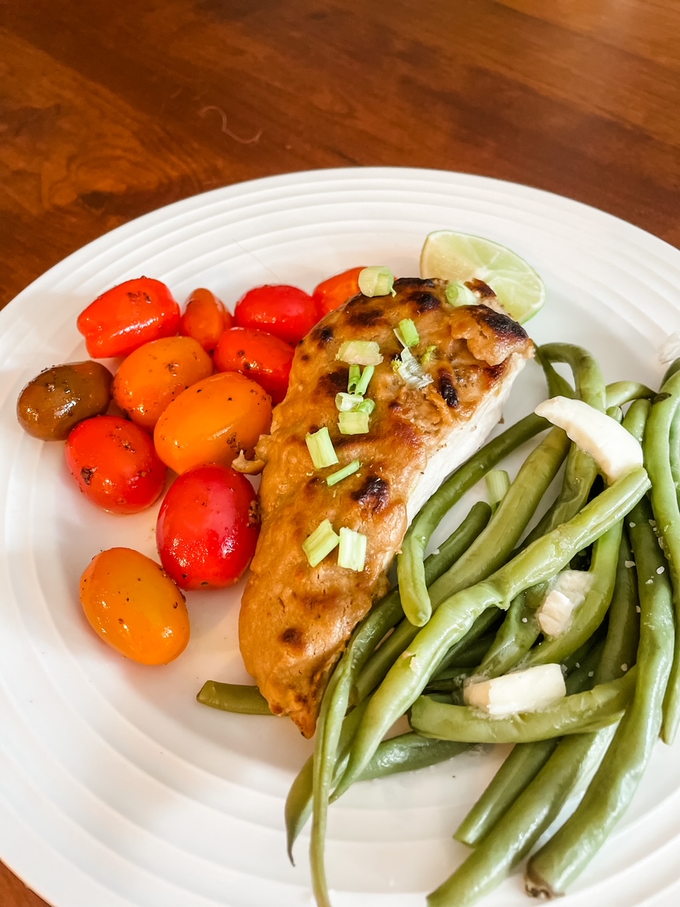 A plate of the 5 Ingredient Peanut Chicken with blistered tomatoes and green beans