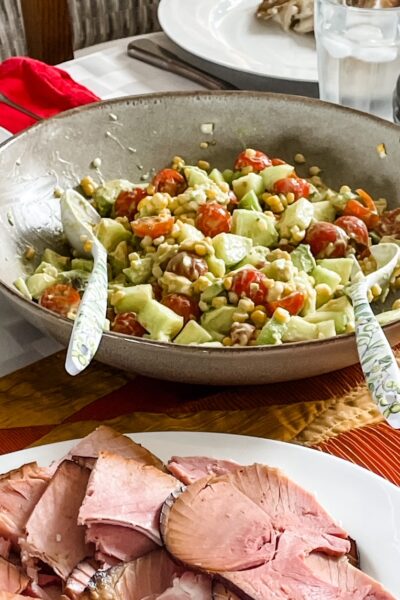 The finishes Cucumber, Corn and Tomato Salad with Easy Avocado Dressing as a side dish