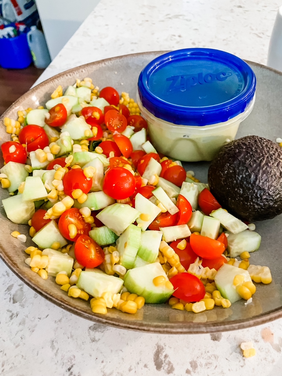 The Cucumber, Corn and Tomato Salad with Easy Avocado Dressing assembled to be taken on-the-go