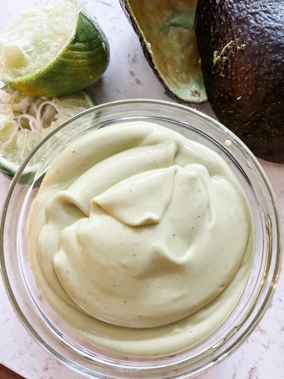 The avocado dressing in a clear cup