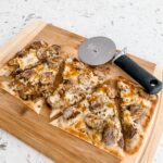 The Sausage, Sauerkraut and Gouda Flatbread sliced into five pieces