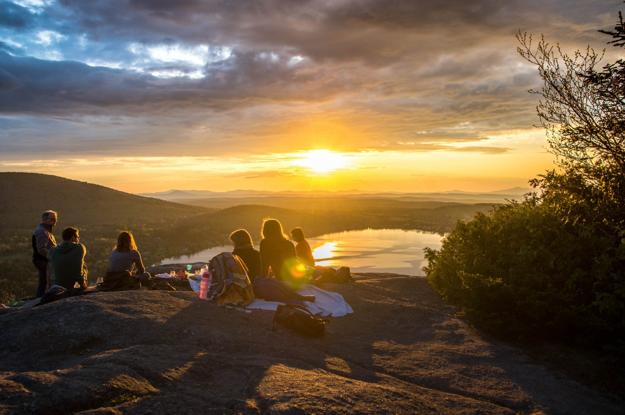 A tour group watching the sun set during a hike