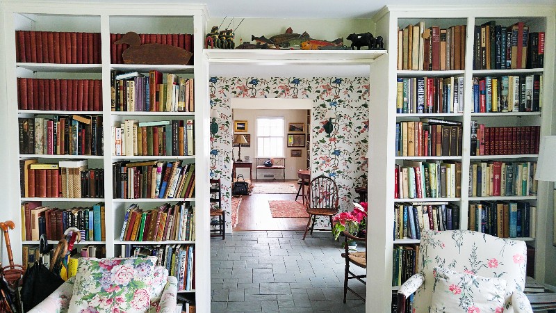 A view of a room's entryway lined with bookshelves