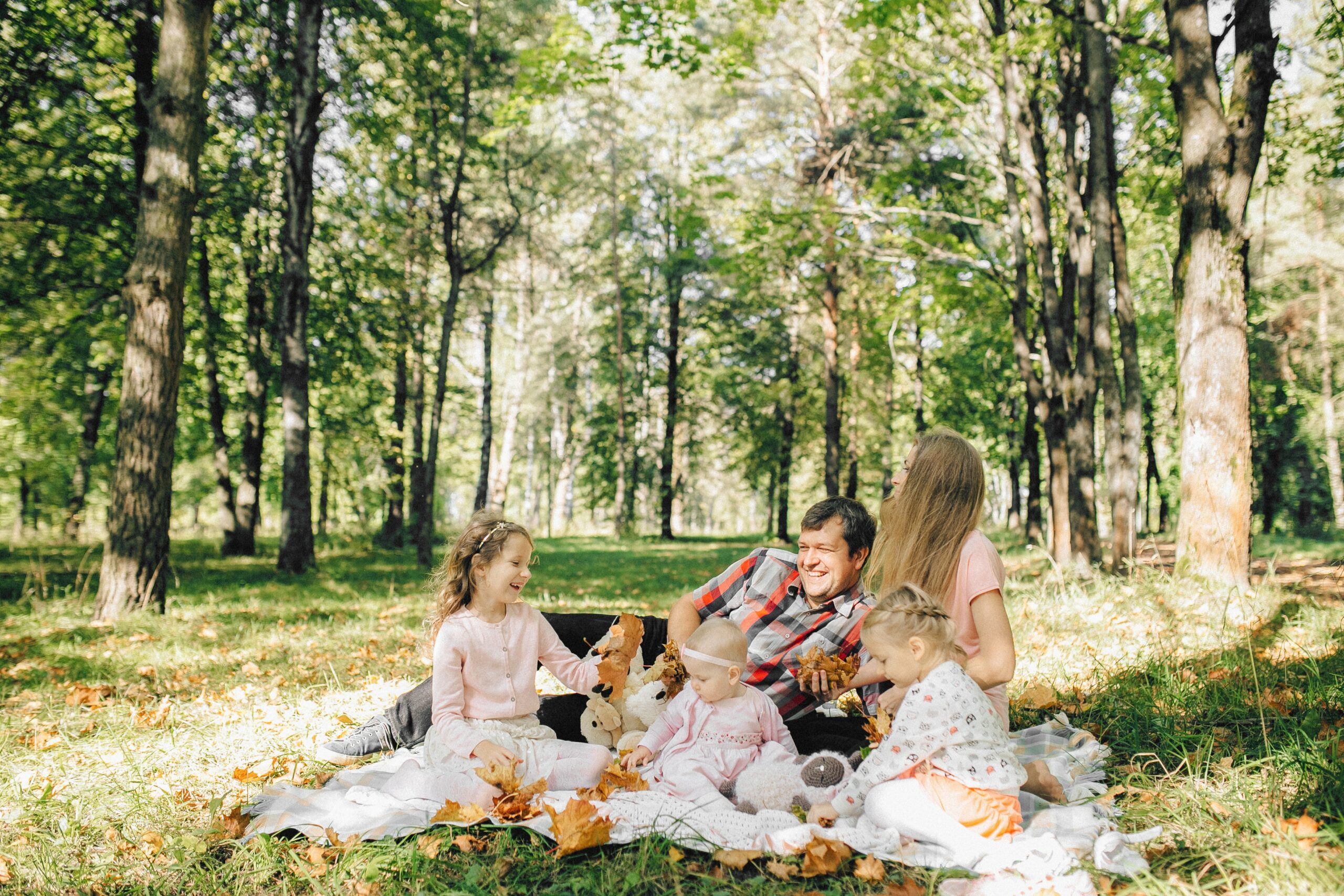 A man having a picnic with his granddaughters - The Guide to Giving Experiences as Gifts
