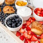 A close up of the berries strewn between the bowls of other berries