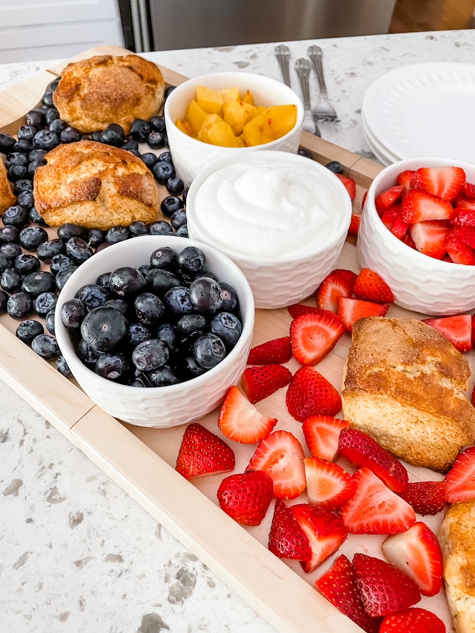 A close up of the berries strewn between the bowls of other berries