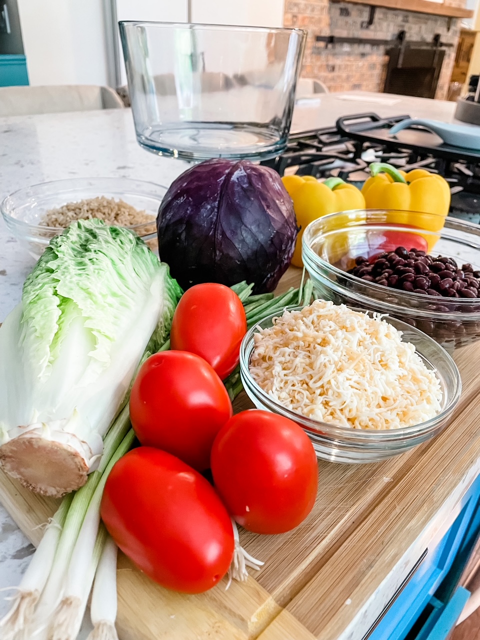 The ingredients - lettuce, tomato, cheese, beans, and peppers