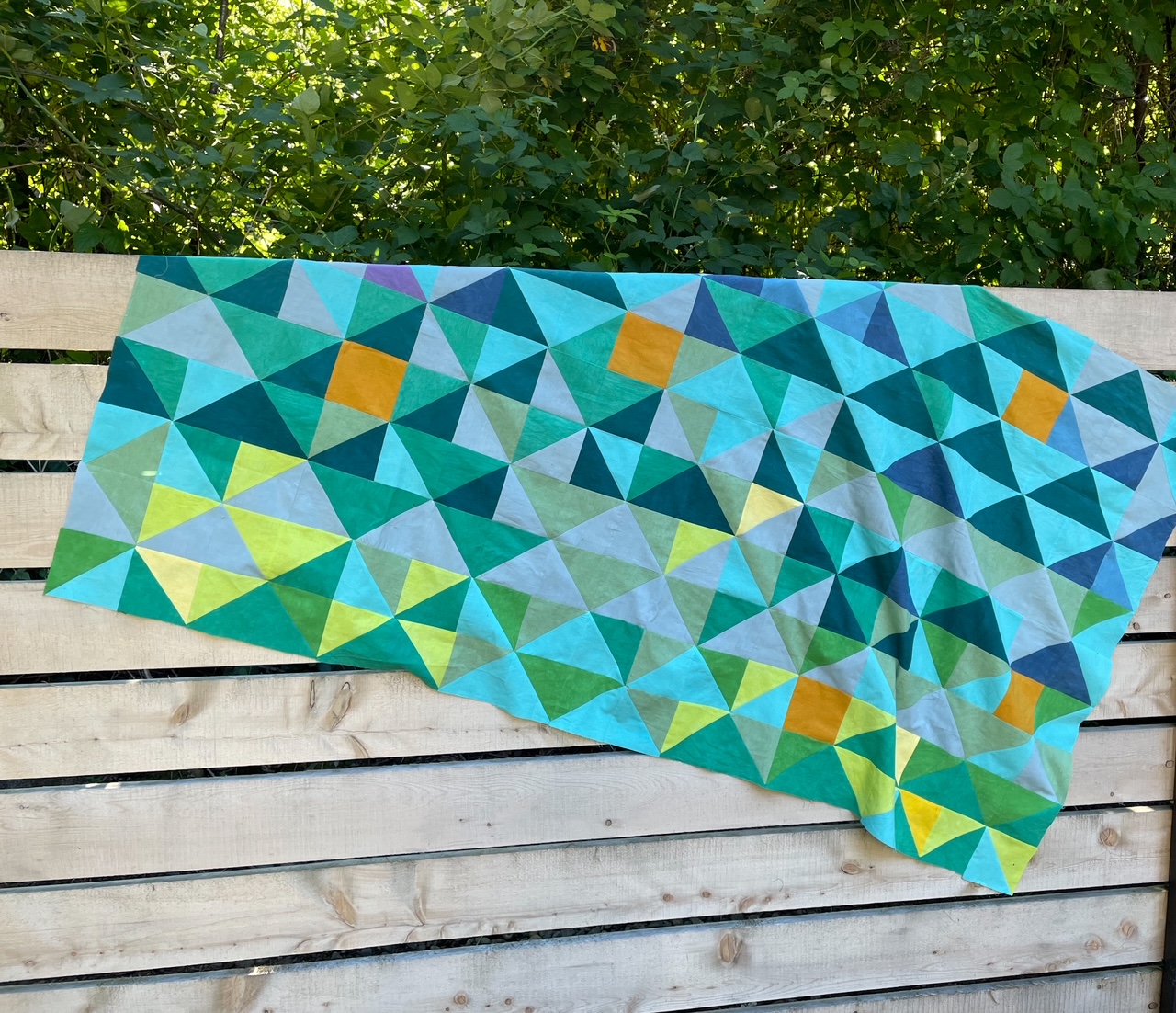 Marie's temperature quilt as of June 23rd, hanging on a wooden fence