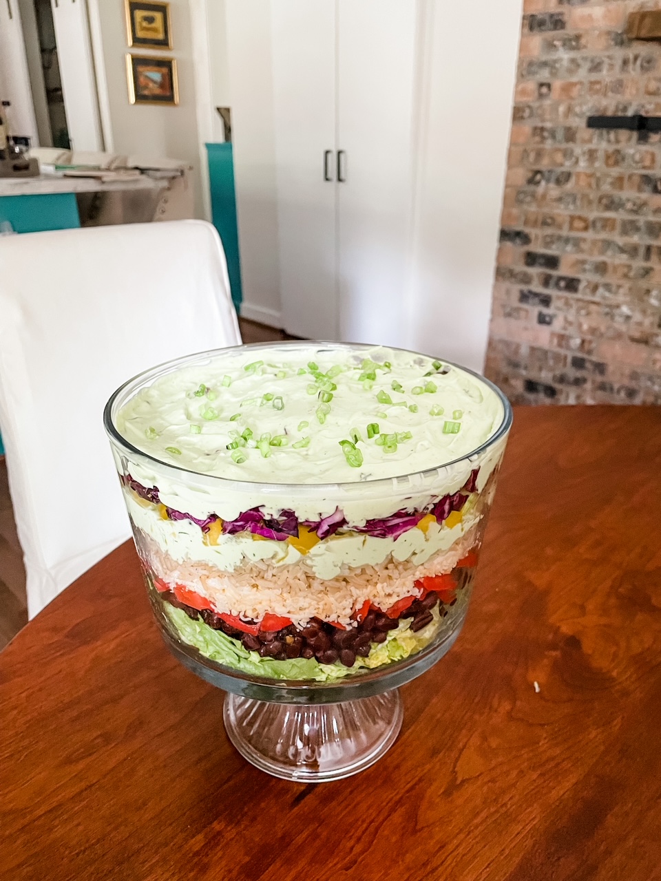 The Vegetarian Layered Salad with Avocado and Lime Dressing served in a trifle dish