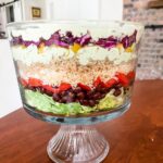 The Vegetarian Layered Salad with Avocado and Lime Dressing served in a trifle dish