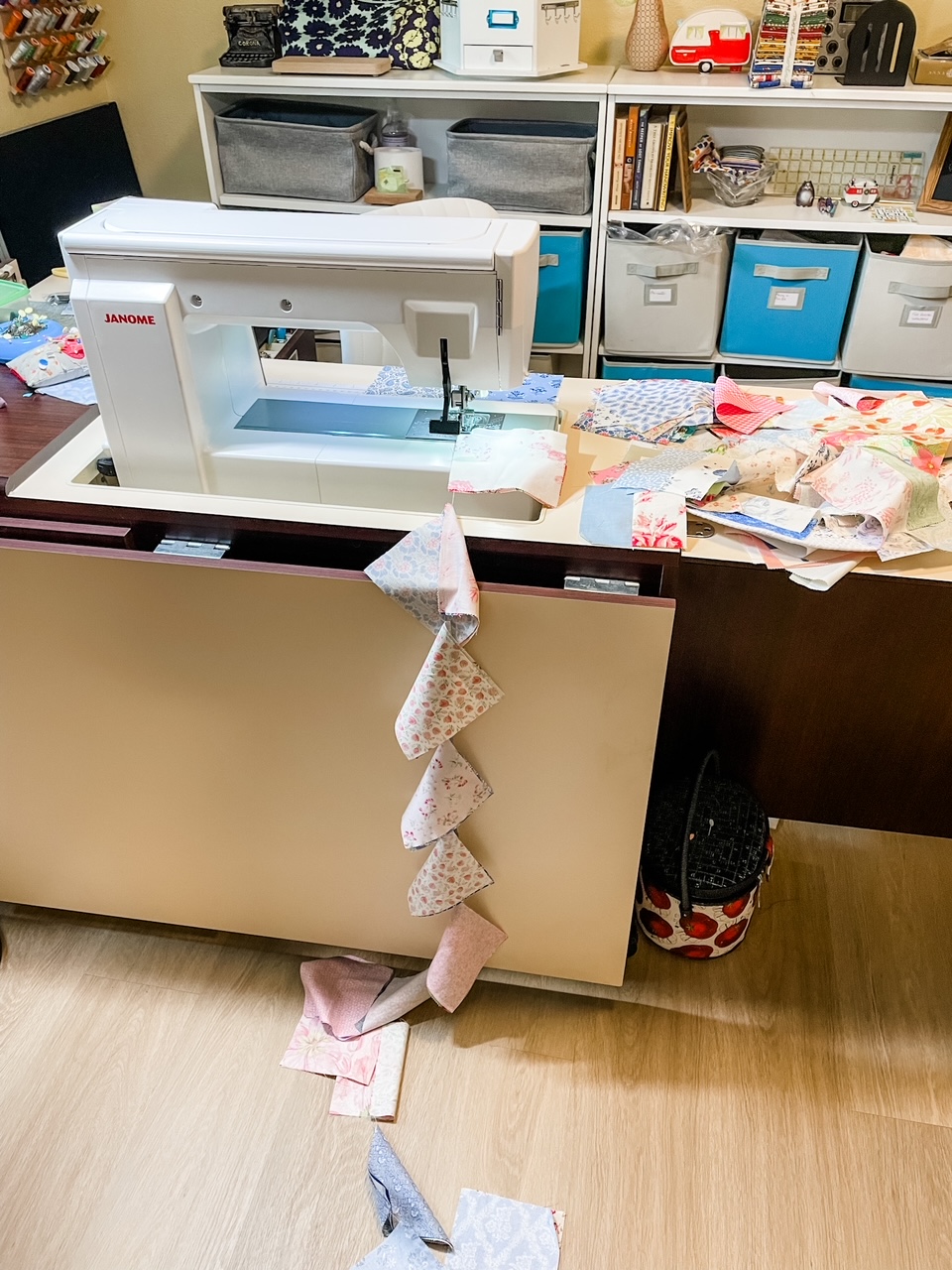 The fabric squares being sewn together into a 'snake'