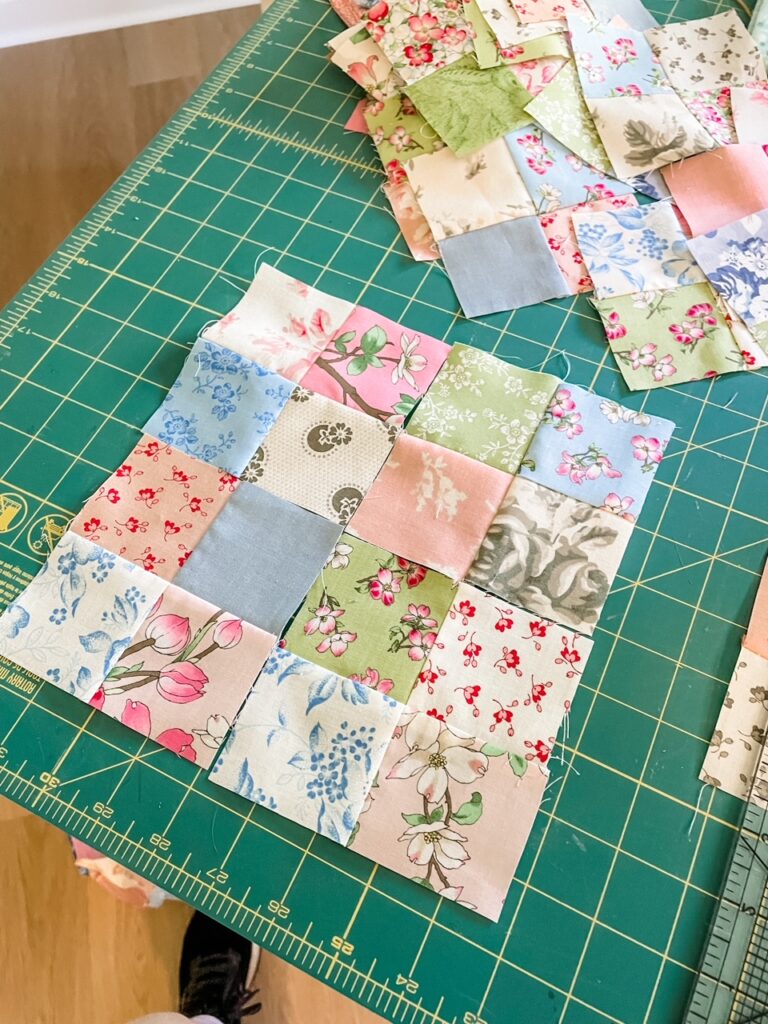 A classic sixteen patch quilt block, made from scraps of pastel colored fabric