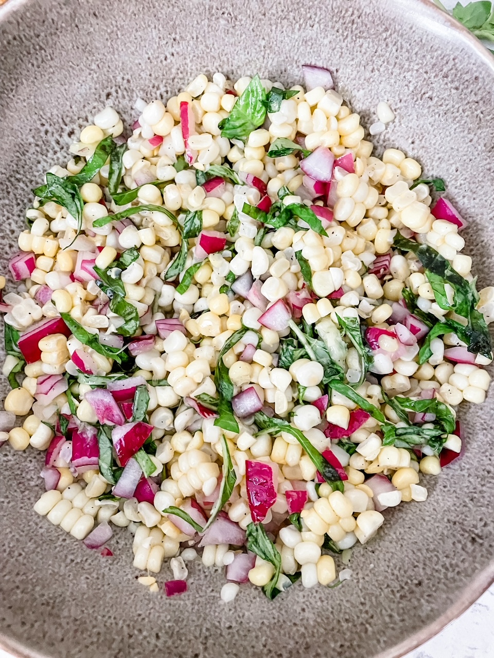 The finished Barefoot Contessa’s BEST Corn and Basil Salad served in a bowl