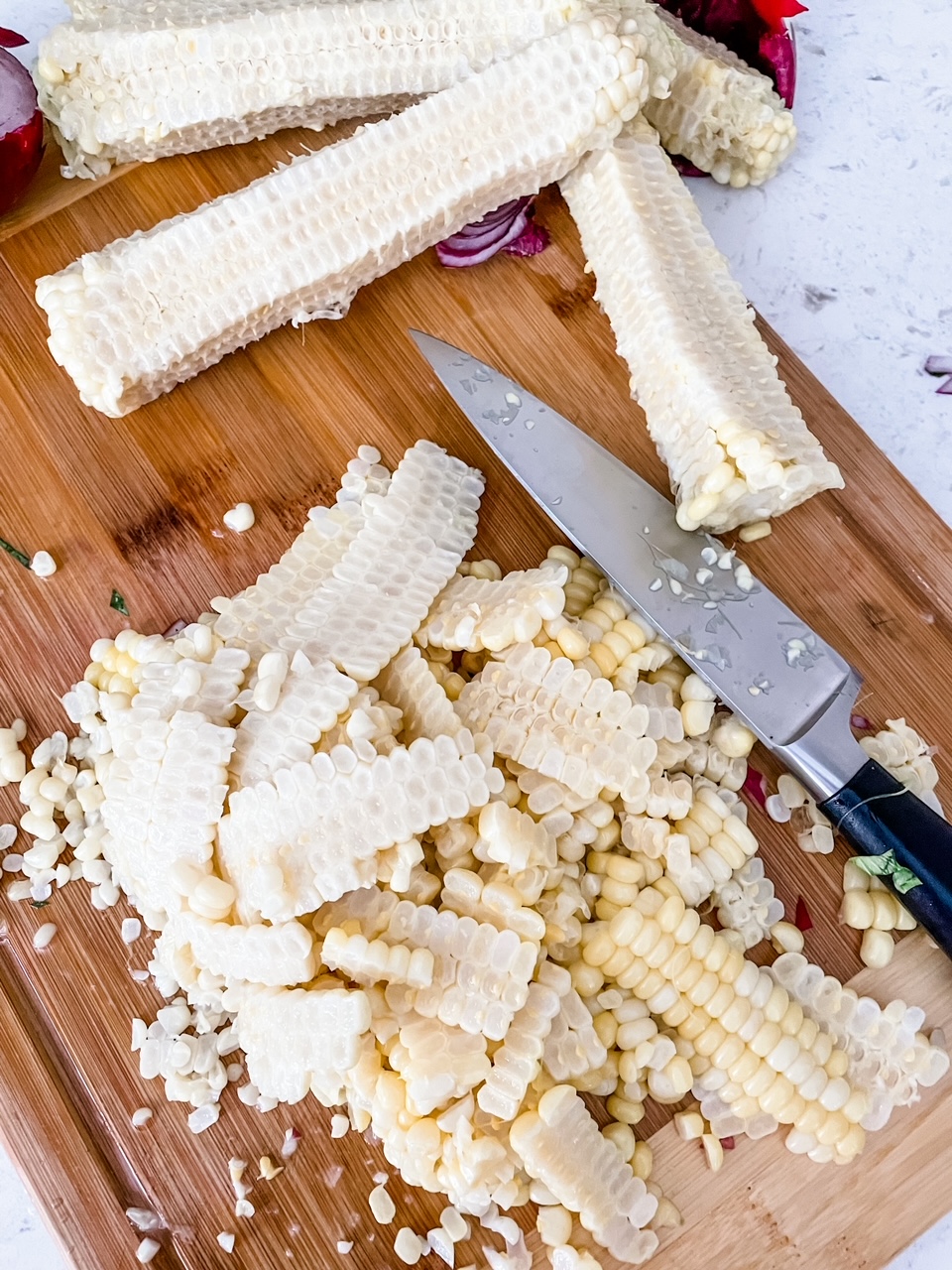 The shaved corn cobs on a cutting board