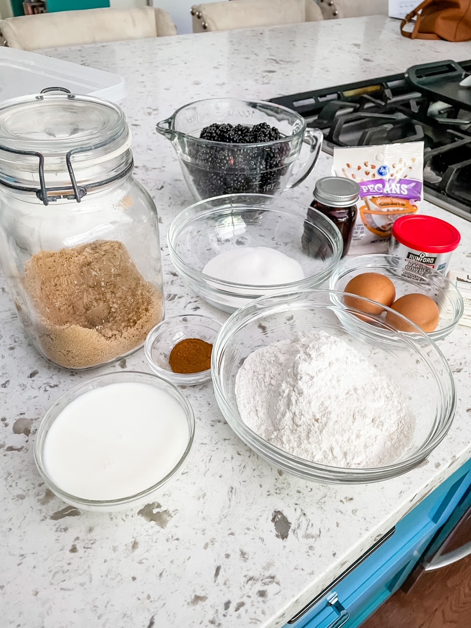 The ingredients - flour, sugar, berries, eggs and more, lined up on a counter.