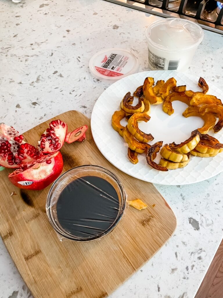 The ingredients for the Easy Thanksgiving Appetizer - balsamic vinegar, pomegranates, delicata squash and burrata 