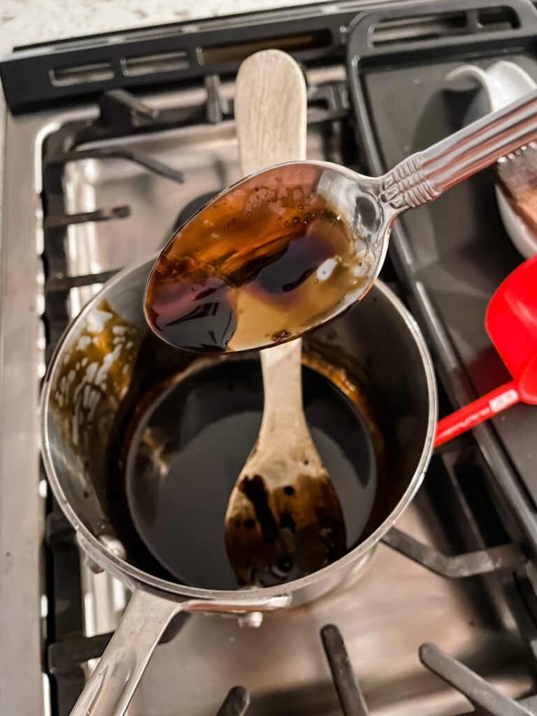 Marie demonstrating the thickness needed for the balsamic vinegar reduction