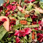 The finished Chicory, Pear and Pomegranate Salad with Cranberry Vinaigrette in a bowl