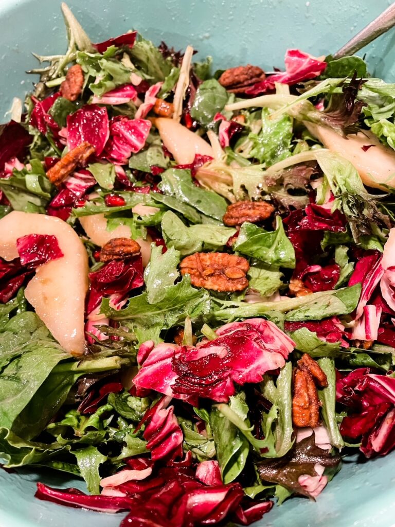The finished Chicory, Pear and Pomegranate Salad with Cranberry Vinaigrette in a bowl